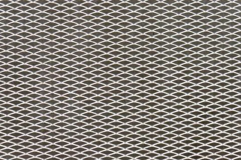 Metal mesh grid pattern creating structured texture background Stock Photos