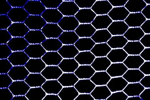 The metal mesh grille is hexagonal. View from the front by the light on a bla Stock Photos