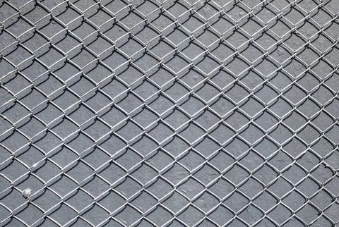 Metal mesh pattern over painted grunge wall background. 스톡 사진