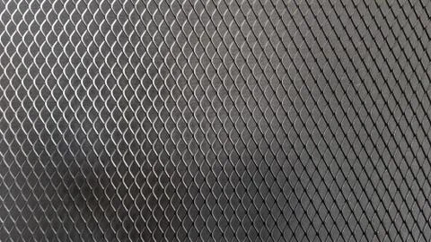 Metal mesh seamless pattern. Black metal mesh texture on a black background. Foto stock