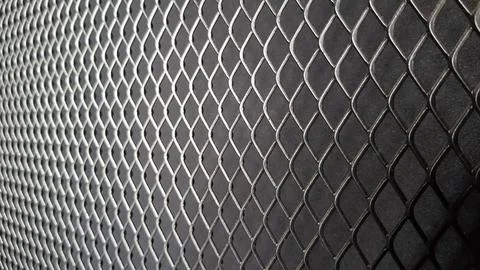 Metal mesh seamless pattern. Black metal mesh texture on a black background.. Stock Photos