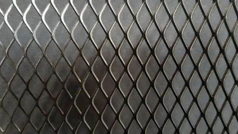 Metal mesh seamless pattern. Black metal mesh texture on a black background.. Stock Photos