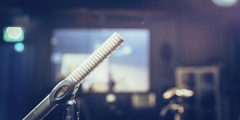 Metal microphone in the studio, studio lights in the blurry background Stock Photos