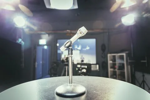Metal microphone in the studio, studio lights in the blurry background Stock Photos