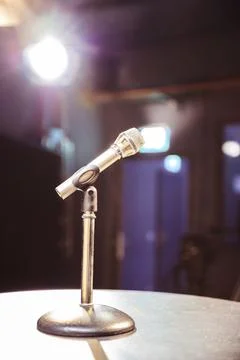 Metal microphone in the studio, studio lights in the blurry background Stock Photos