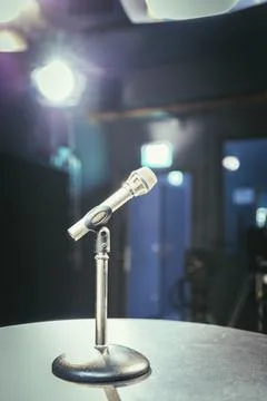 Metal microphone in the studio, studio lights in the blurry background Stock Photos