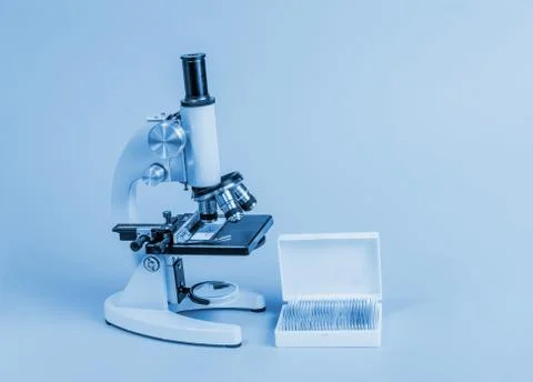 Metal microscope on blue background Stock Photos