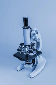 Metal microscope on blue background Stock Photos
