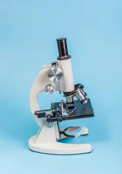 Metal microscope on blue background Stock Photos