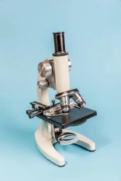 Metal microscope on blue background Stock Photos