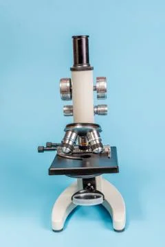 Metal microscope on blue background Stock Photos