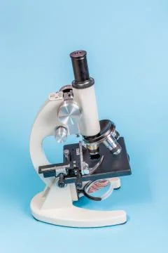 Metal microscope on blue background Stock Photos