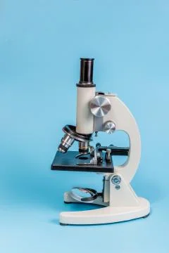 Metal microscope on blue background Stock Photos