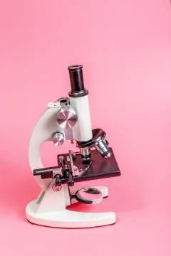 Metal microscope on pink base Stock Photos