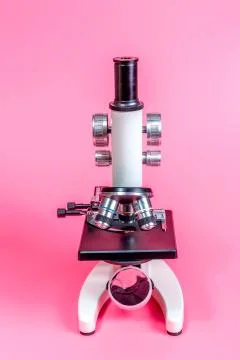 Metal microscope on pink base Stock Photos