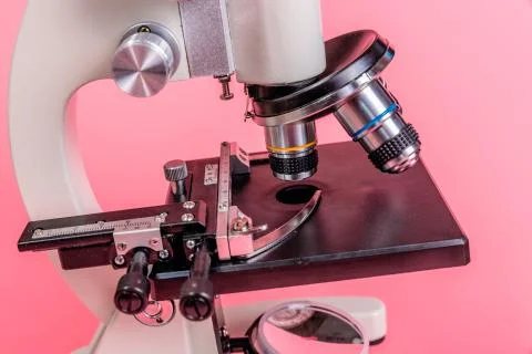 Metal microscope on pink base Stock Photos