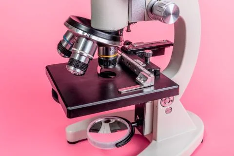 Metal microscope on pink base Stock Photos