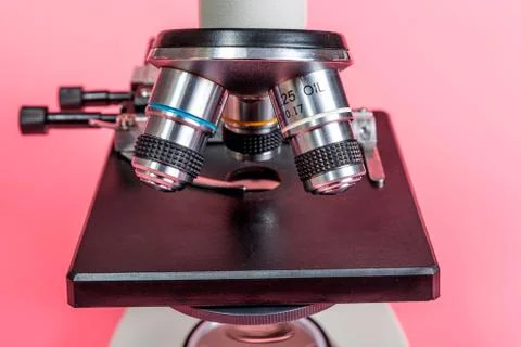 Metal microscope on pink base Stock Photos