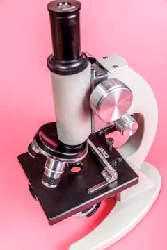 Metal microscope on pink base Stock Photos