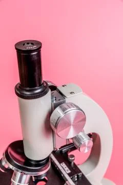 Metal microscope on pink base Stock Photos
