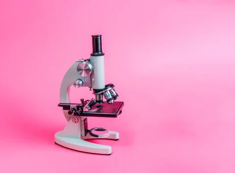 Metal microscope on pink base Stock Photos
