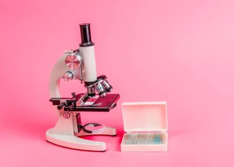 Metal microscope on pink base Stock Photos