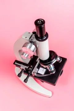 Metal microscope on pink base Stock Photos