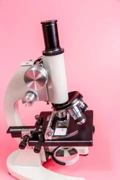 Metal microscope on pink base Stock Photos