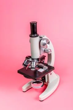 Metal microscope on pink base Stock Photos
