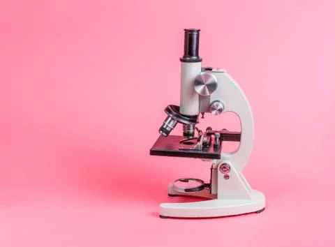 Metal microscope on pink base Stock Photos