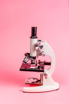 Metal microscope on pink base Stock Photos