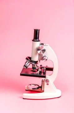 Metal microscope on pink base Stock Photos