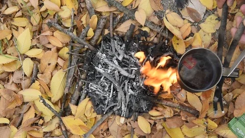 Metal mug, a cup over the fire. A cup of tea. Stock Footage 101355929