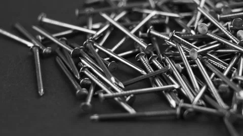 Metal nails on a black background. Carpentry industrial instrument and tools Stock Footage 219774588