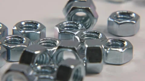Metal nut nuts for tools and bolts in slo mo 4k studio Video stock 329707294