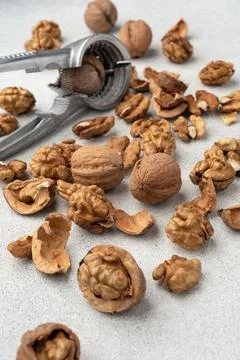 Metal nutcracker with scattered walnut shells. Minimal still life concept of  Stock Photos