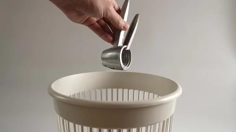 The metal nutcracker is thrown into the trash for recycling. Slow motion. Stock Footage 261363092