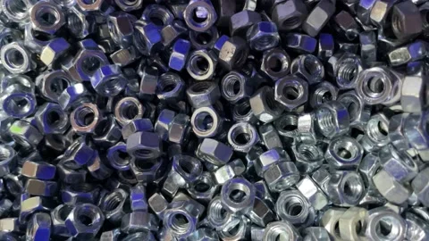 Metal nuts are in bulk in a construction store in a box Stock Footage 216718106
