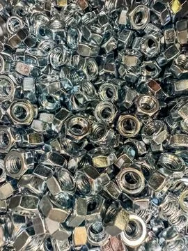 Metal nuts background. Working tools. Fixing elements Stock Photos