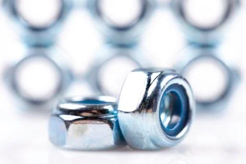 Metal nuts closeup background Stock Photos