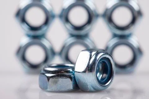 Metal nuts closeup background Stock Photos