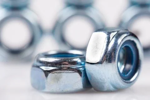 Metal nuts closeup on white background Stock Photos