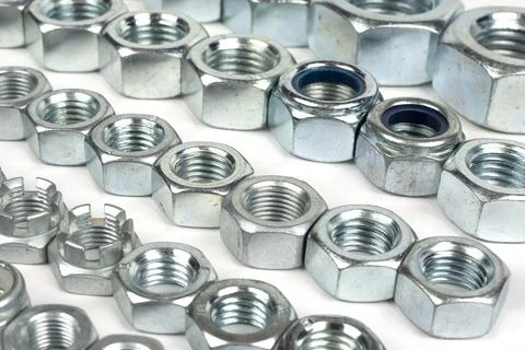 Metal nuts of different sizes in several lines Stock Photos