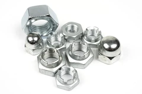 Metal nuts of different types on a white background Stock Photos