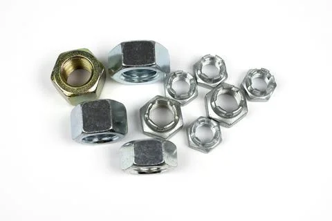 Metal nuts of different types on a white background Foto stock