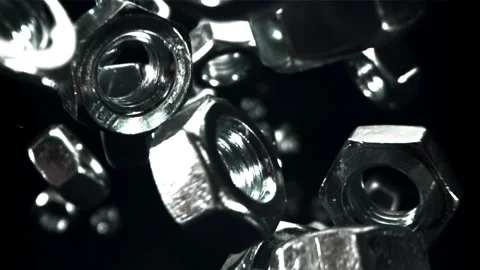 Metal nuts fall down. Filmed on a high-speed camera at 1000 fps. Stock Footage 307930675
