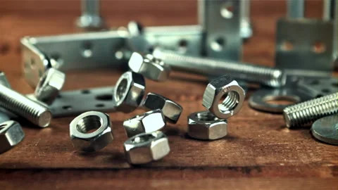 Metal nuts fall on the wooden table. Filmed is slow motion 1000 frames per 스톡 동영상 167093613