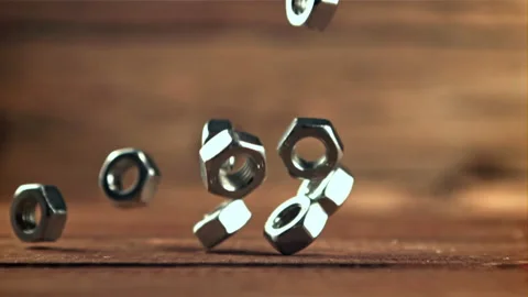 Metal nuts fall on the wooden table. Filmed is slow motion 1000 frames per 스톡 동영상 167797075