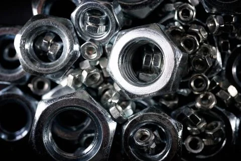 Metal nuts group on a table Fotos de archivo