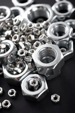 Metal nuts group on a table Fotos de archivo